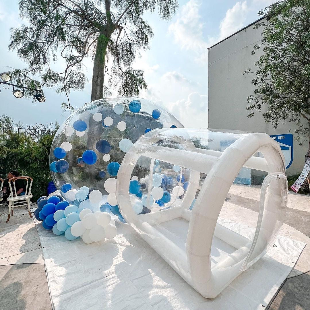 Clear bubble house structure by Aura Luxury Rental Ltd with transparent walls and rounded shape, set outdoors.
