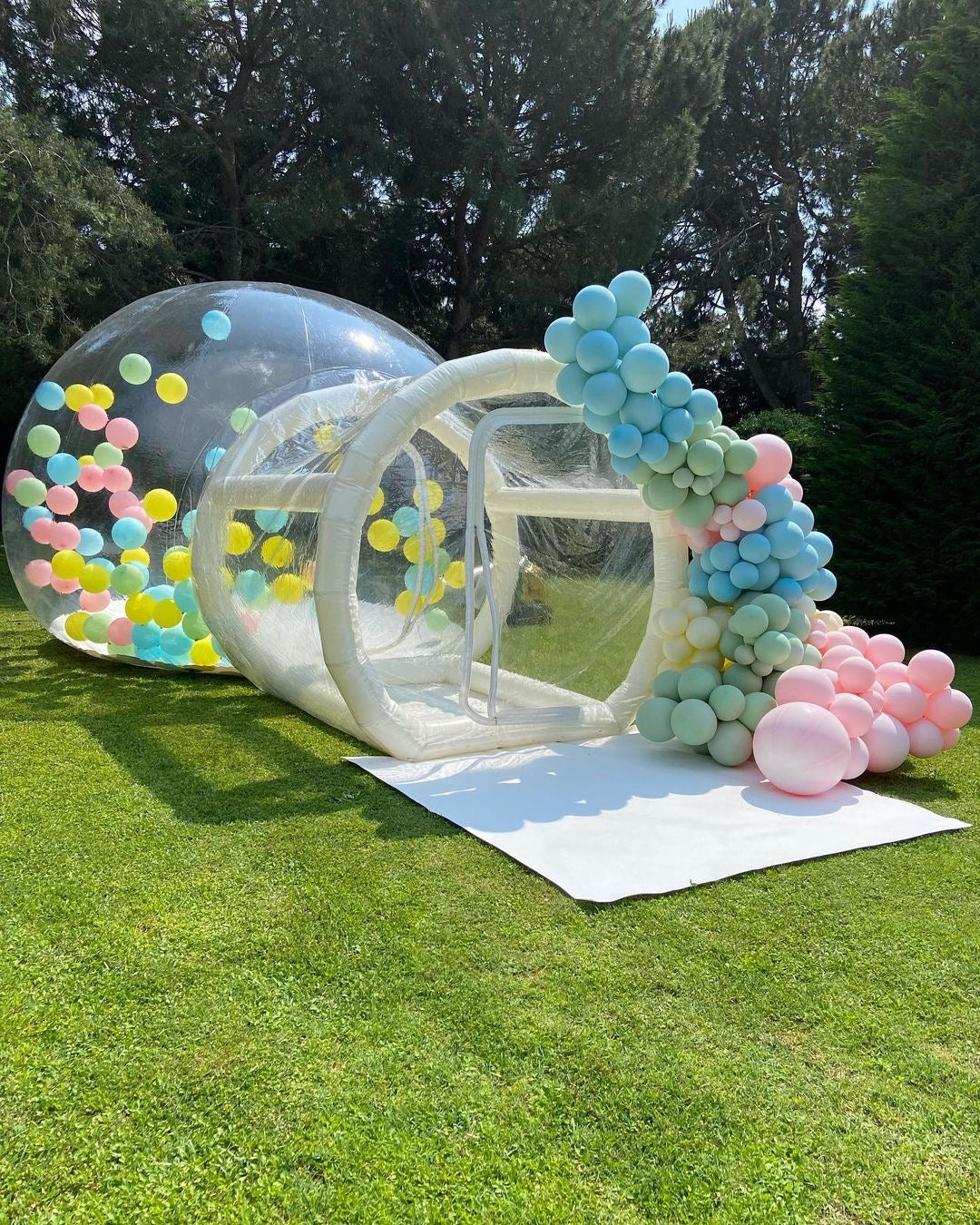 Glass Bubble House by Aura Luxury Rental Ltd with transparent walls and modern design, set outdoors on lush green grass.