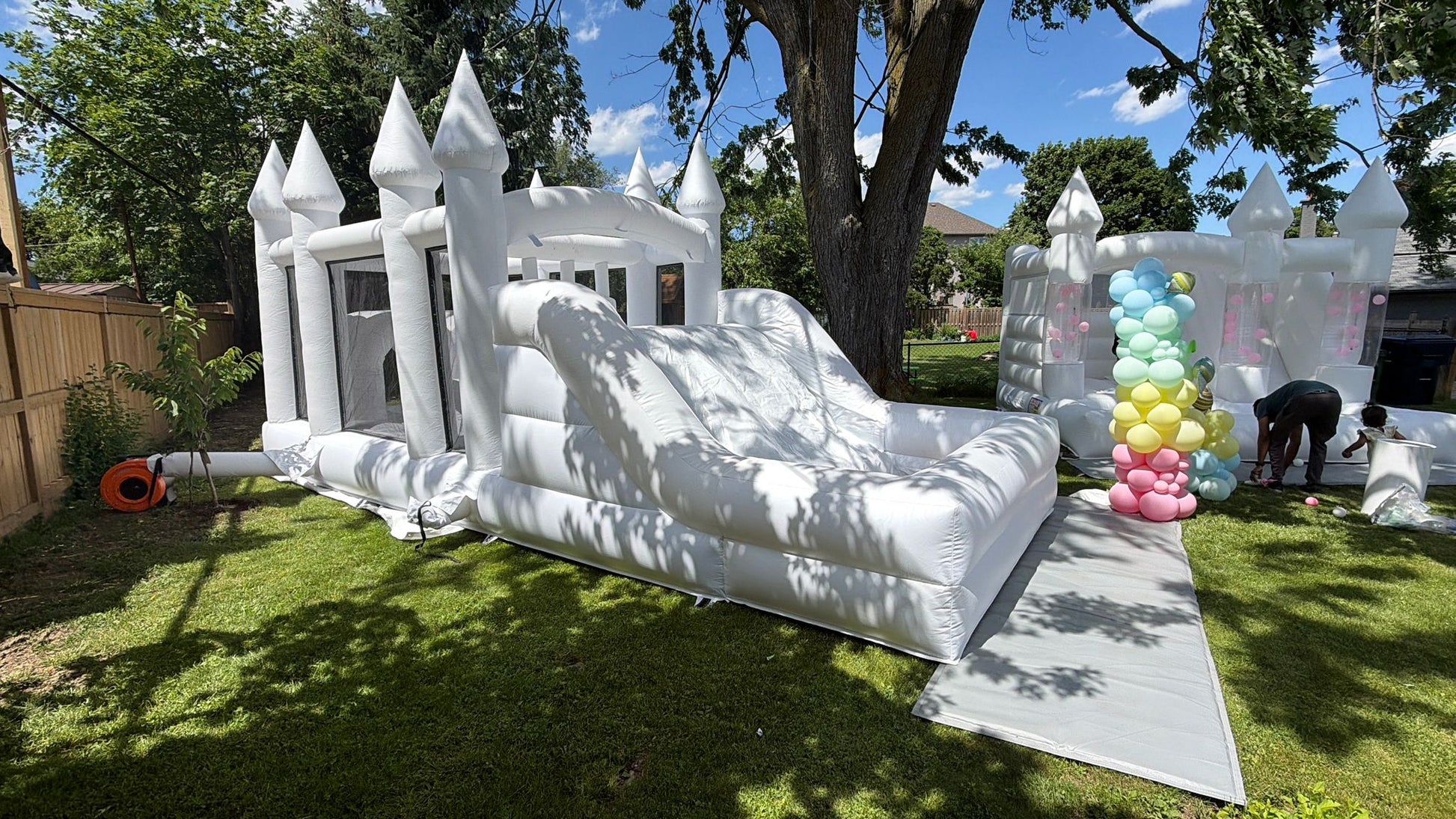 Colorful obstacle course with ball pit and waterslide designed for kids, featuring bright play elements from Aura Luxury Rental Ltd.