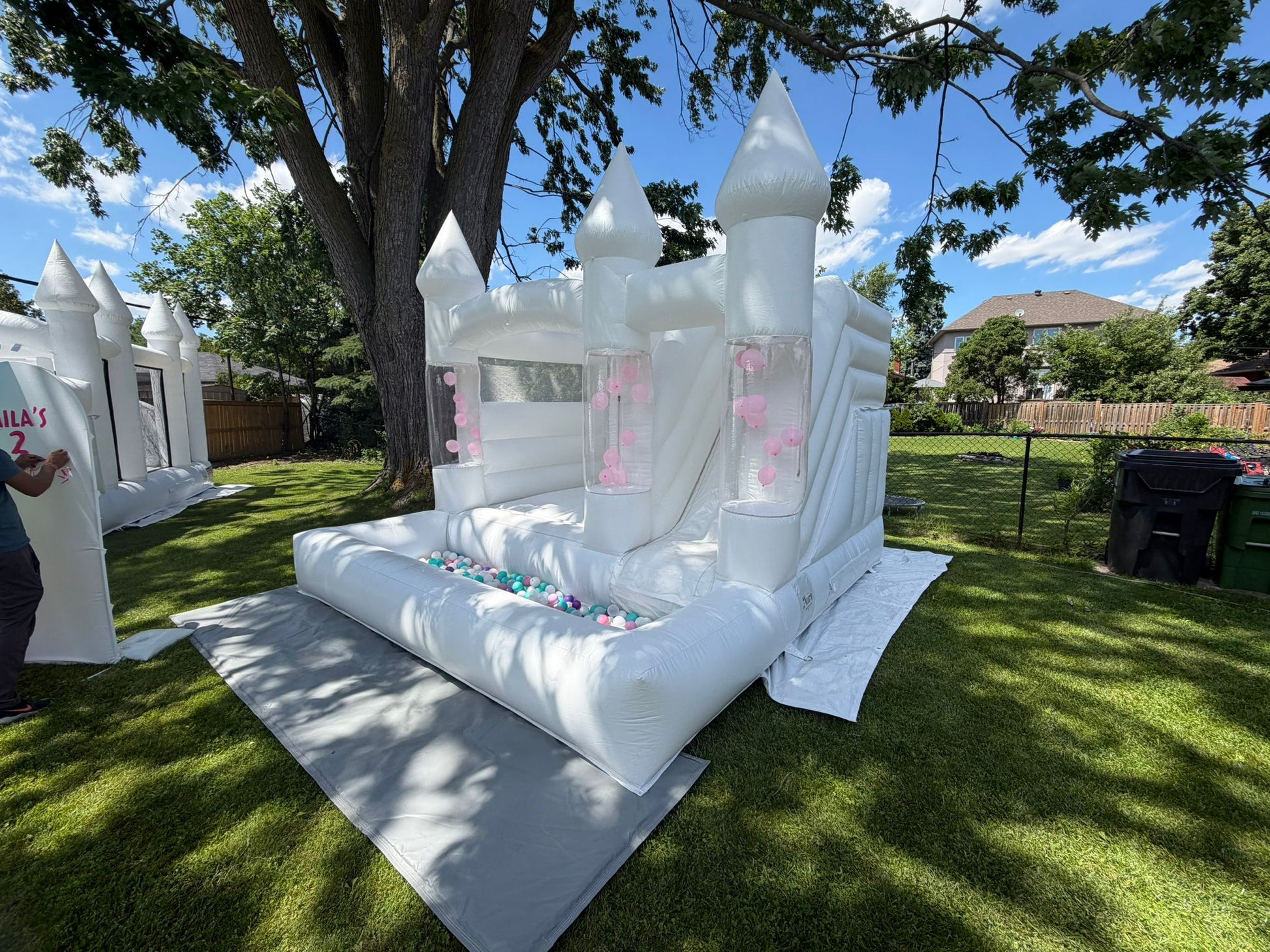 White balloon pillar castle with slide and ballpit, inflatable party bounce house by Aura Luxury Rental Ltd.