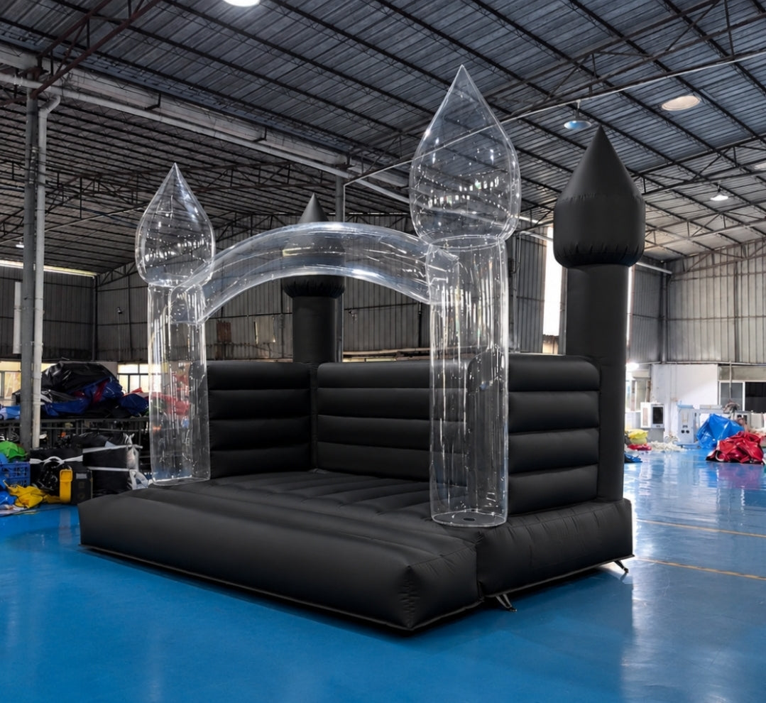 Black bouncy castle from Aura Luxury Rental Ltd, featuring colorful inflatable arches and vibrant jumping surface for kids' outdoor fun.